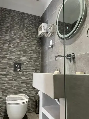 a bathroom with a sink and a toilet and a mirror at Joanna Apartments in Haraki