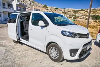 a white van parked in a parking lot with its door open at Joanna Apartments in Haraki