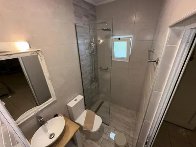 a bathroom with a shower and a toilet and a sink at Bay View in Faliraki