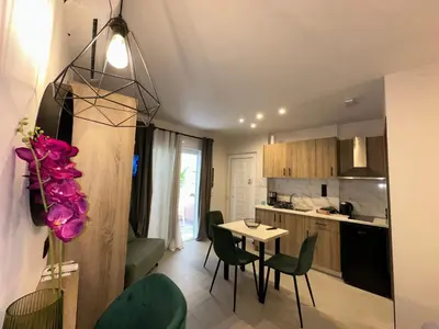 a kitchen and dining room with a table and chairs at Bay View in Faliraki