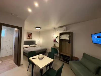 a room with a bed and a table and a couch at Bay View in Faliraki