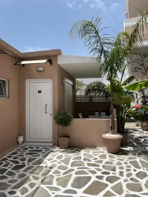 a front door of a house with potted plants at Bay View in Faliraki