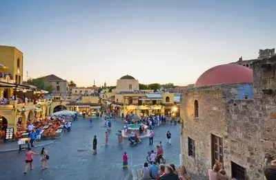 a group of people walking around a city street at Naria Medieval House in Rhodes Town