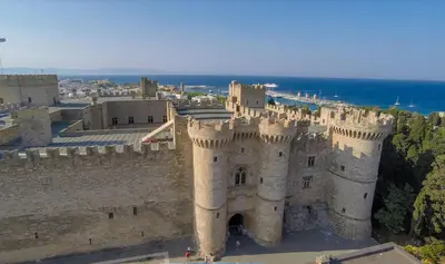 an old castle with the ocean in the background at Naria Medieval House in Rhodes Town