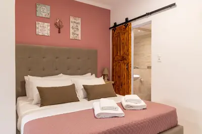 a bedroom with a large bed with two towels on it at Naria Medieval House in Rhodes Town