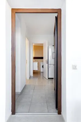 an open door to a kitchen with a refrigerator at Memi Beach front Villa in Kiotari