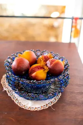 a bowl of fruit sitting on top of a table at Conchiglia Village House in Kiotari
