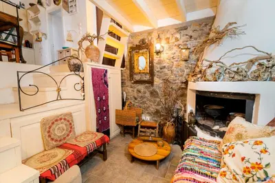a living room with a couch and a fireplace at Conchiglia Village House in Kiotari