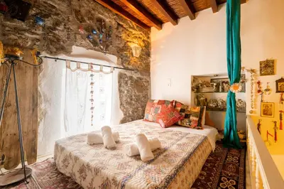 a bedroom with a bed with towels on it at Conchiglia Village House in Kiotari