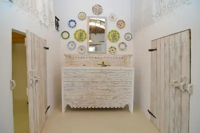 a bathroom with a dresser and plates on the wall at Rhodes Archangelos Traditional village house in with private yard in Archangelos