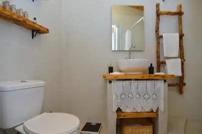 a bathroom with a white toilet and a sink at Rhodes Archangelos Traditional village house in with private yard in Archangelos