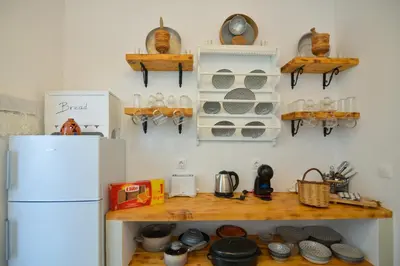 a kitchen with a white refrigerator and a wooden counter at Rhodes Archangelos Traditional village house in with private yard in Archangelos