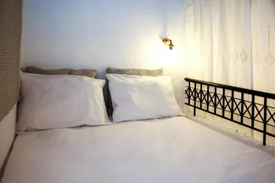 a bed with two white pillows on it at Rhodes Archangelos Traditional village house in with private yard in Archangelos