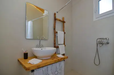 a bathroom with a sink and a mirror at Rhodes Archangelos Traditional village house in with private yard in Archangelos