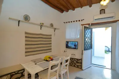a kitchen and dining room with a table and chairs at Rhodes Archangelos Traditional village house in with private yard in Archangelos