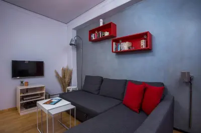 a living room with a gray couch and red pillows at Anna's house in the Old Town in Rhodes Town