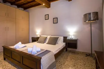 a bedroom with a bed with two towels on it at Anna's house in the Old Town in Rhodes Town