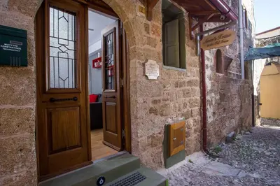 an entrance to a stone building with a wooden door at Anna's house in the Old Town in Rhodes Town