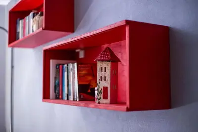 a red book shelf with a toy house on it at Anna's house in the Old Town in Rhodes Town