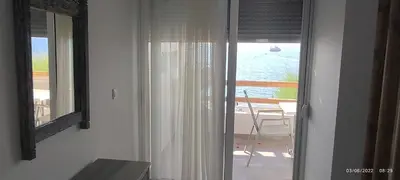 a room with a window with a view of the ocean at Ammos stegna in Archangelos