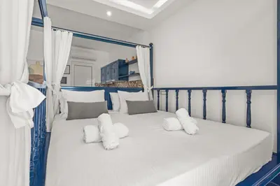 a white bed with white pillows in a bedroom at Ammos stegna in Archangelos