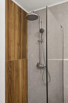 a shower with a glass door in a bathroom at Ammos stegna in Archangelos
