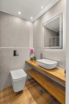 a bathroom with a sink and a toilet and a mirror at Ammos stegna in Archangelos