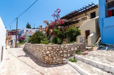 a stone wall in front of a house at Kiki&Nina in Halki