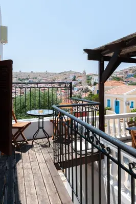 a balcony with a table and a view of the city at Kiki&Nina in Halki