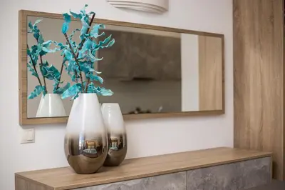 two vases sitting on a shelf in front of a mirror at Dimitra Faliraki Center Apartments in Faliraki