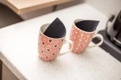 two coffee mugs sitting on top of a counter at Dimitra Faliraki Center Apartments in Faliraki