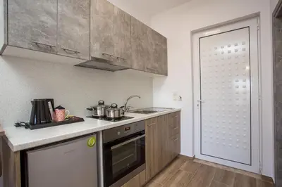 a kitchen with a sink and a stove at Dimitra Faliraki Center Apartments in Faliraki