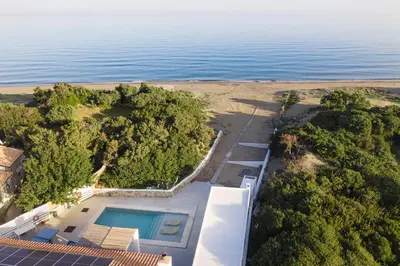 an aerial view of a house with a swimming pool at Cathrin Beachfront Villa in Plimmiri