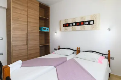 two beds sitting next to each other in a bedroom at Cathrin Beachfront Villa in Plimmiri