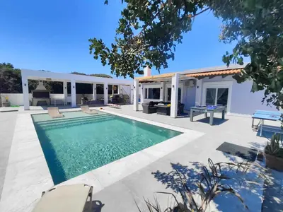 a villa with a swimming pool and a house at Cathrin Beachfront Villa in Plimmiri