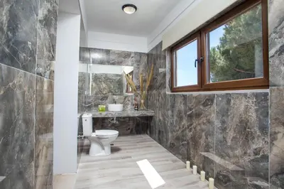 a bathroom with a toilet and a window at MonaLisa Villa in Pefki Rhodes