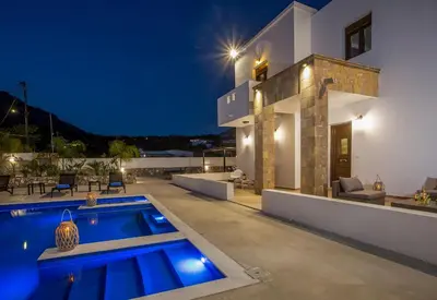 a villa with a swimming pool at night at MonaLisa Villa in Pefki Rhodes