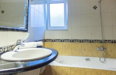 a bathroom with a toilet and a sink and a tub at Heliopetra Villa in Koskinou
