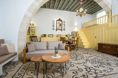 a living room with a couch and a table at Marouli Traditional Villa in Koskinou