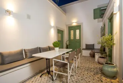 a dining room with a table and chairs at Marouli Traditional Villa in Koskinou