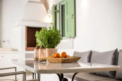 a table with a bowl of oranges on top of it at Marouli Traditional Villa in Koskinou