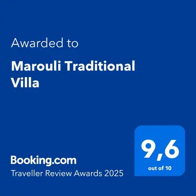 a blue sign with the text awarded to akanu traditional villa at Marouli Traditional Villa in Koskinou