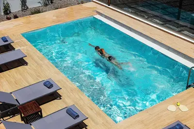 a person swimming in a swimming pool at Kipos Suites & Apartments in Gennadi