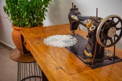 an old sewing machine sitting on top of a wooden table at Kipos Suites & Apartments in Gennadi