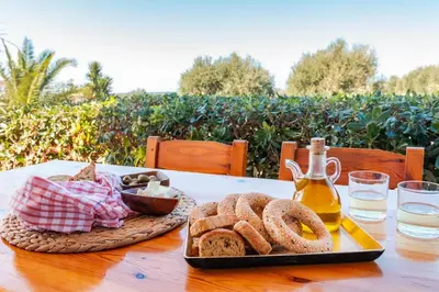 a table with a tray of bread and a bottle of beer at Alonia Summerhouse in Fanes in Phanaes