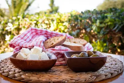 a plate of food with cheese and bread on a table at Alonia Summerhouse in Fanes in Phanaes