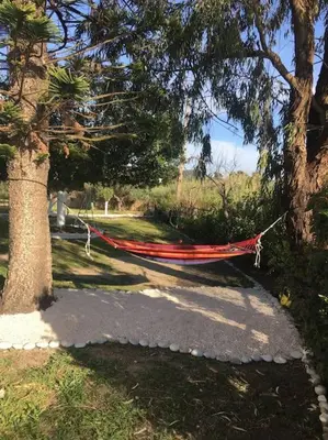 a hammock hanging between two trees in a park at Alonia Summerhouse in Fanes in Phanaes