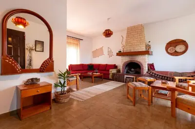 a living room with a couch and a fireplace at Alonia Summerhouse in Fanes in Phanaes