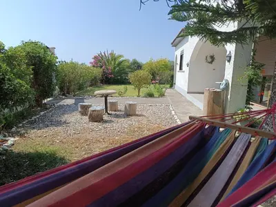 a rainbow hammock in a backyard with a table at Alonia Summerhouse in Fanes in Phanaes