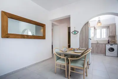 a kitchen and dining room with a table and chairs at Celini beach house in Kiotari